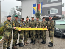 Vor dem LOT-Haus in Vlasenica: Ein Gelbes Band vom BundeswehrVerband für die Truppe: Bei der Übergabe Frank Schmitt, Beauftragter Auslandseinsätze, Oberstleutnant i.G. Marcel Bohnert und Major Ronald Hartwig, Chef des Liaison Operation Teams in Vlasenica. Foto: DBwV/Frank Jungbluth